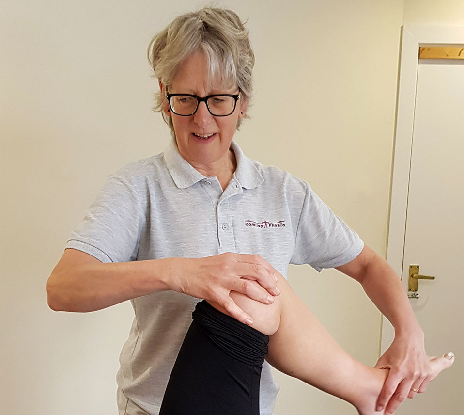 Cathy performing physio on a knee